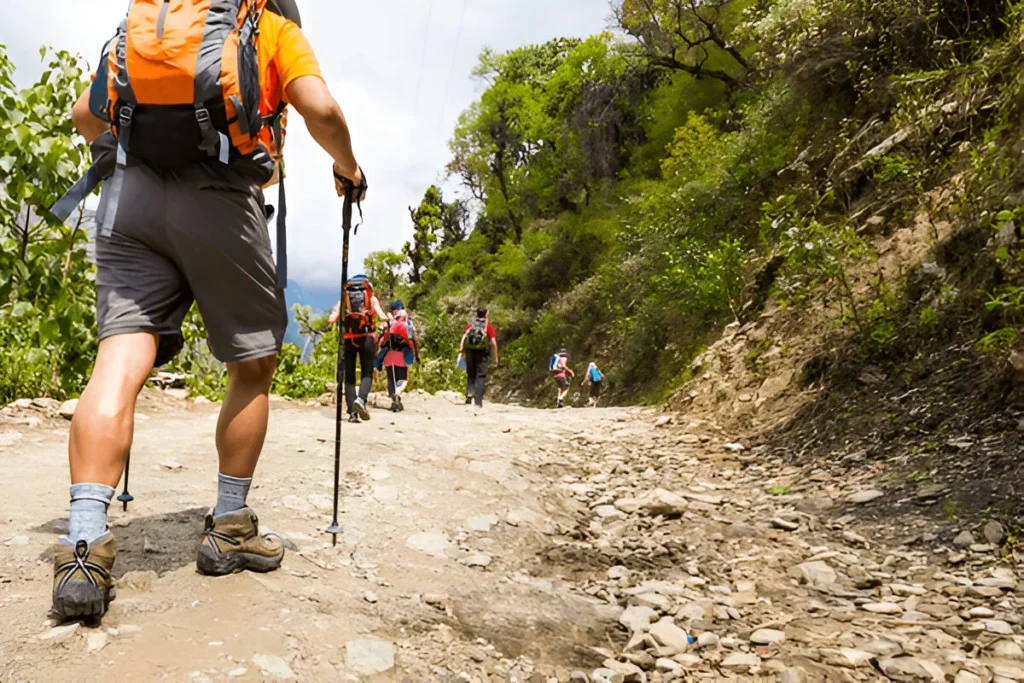 A group of people trekking on dirt road with best hiking gear
