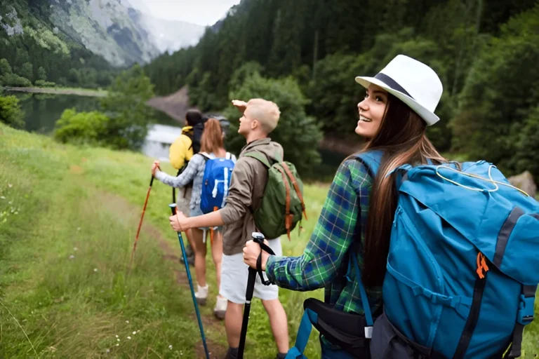 A group of hikers walking through a scenic mountain trail, each carrying gear featuring the Best Ultralight Backpacks.