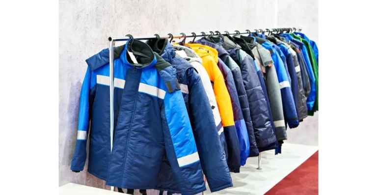A row of colorful winter jackets, including blue and reflective designs, hangs on a clothing rack in a retail store. Featured among the options is the Best Ultralight Rain Jacket