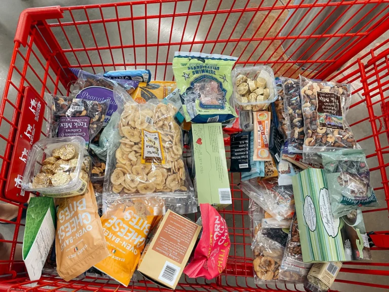 Shopping cart filled with snacks, dried fruits, and packaged foods for a 7-Day Backpacking Meal Plan.