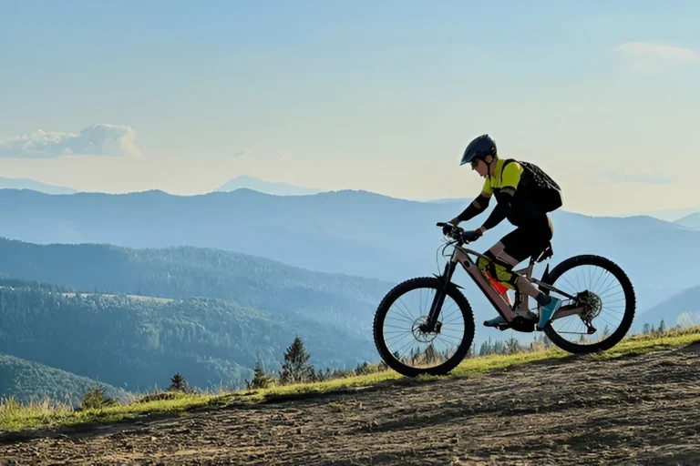 Cyclist riding one of the best folding electric bikes on a scenic mountain trail, showcasing outdoor adventure and mobility.