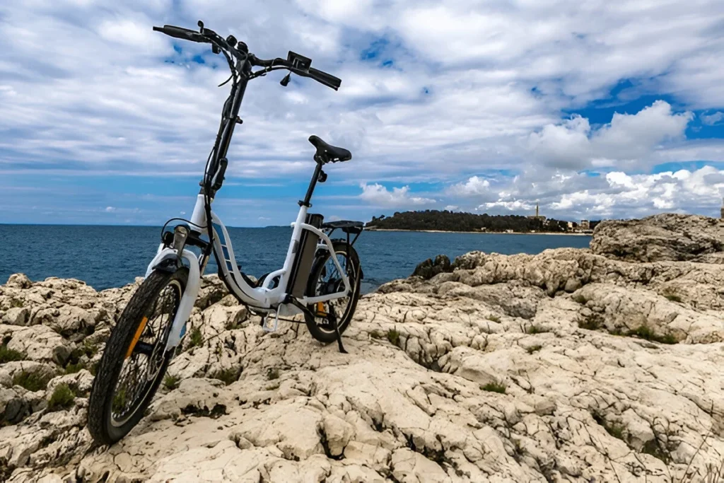 Exploring the Istrian Peninsula on a bicycle tour, electric bicycle on a pebble beach near Rovinj, bicycle paths in Croatia