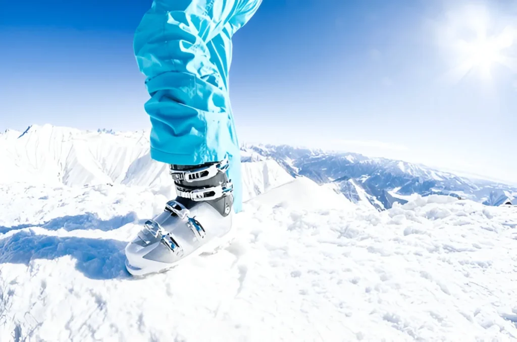 Female model posing her white skiing boots