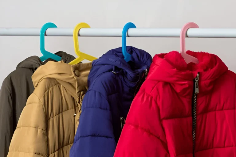 A row of colorful puffer coats hanging on a rack, showcasing some of the Best Down Jackets for cold weather.