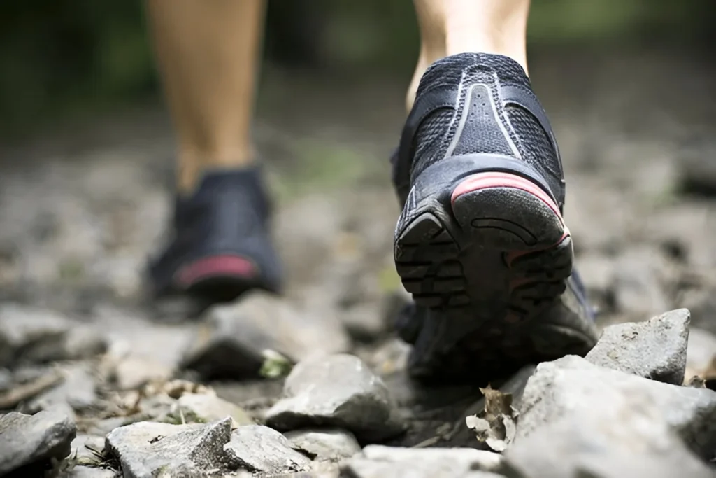 Sport shoes on trail walking in mountains, outdoors activit