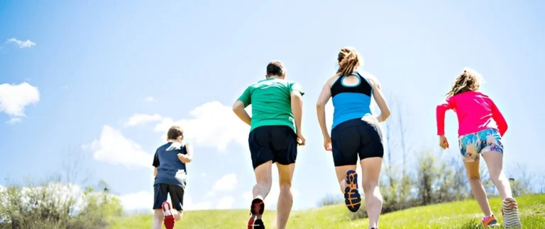Women running uphill in bright, athletic outfits, highlighting the best running shorts for women in action.