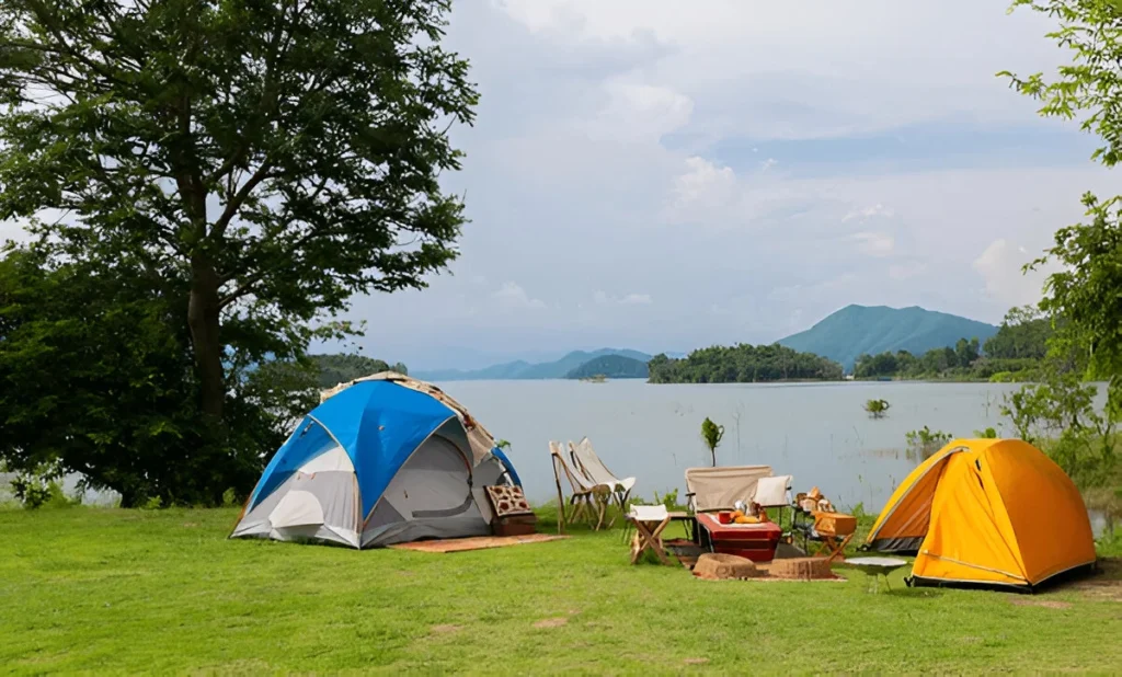 Two tents set up by a serene lakeside campsite, featuring one of the best ultralight tents perfect for lightweight outdoor adventures.