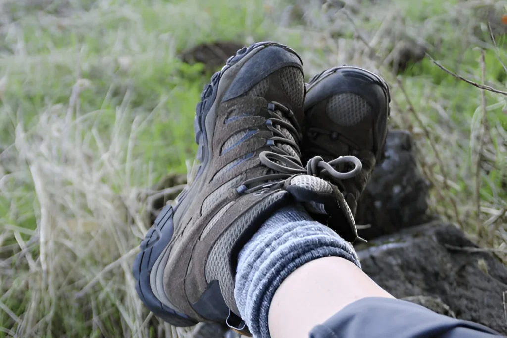 Close-up of a hiker relaxing with rugged footwear, showcasing comfort and durability in some of the best hiking boots for outdoor adventures.
