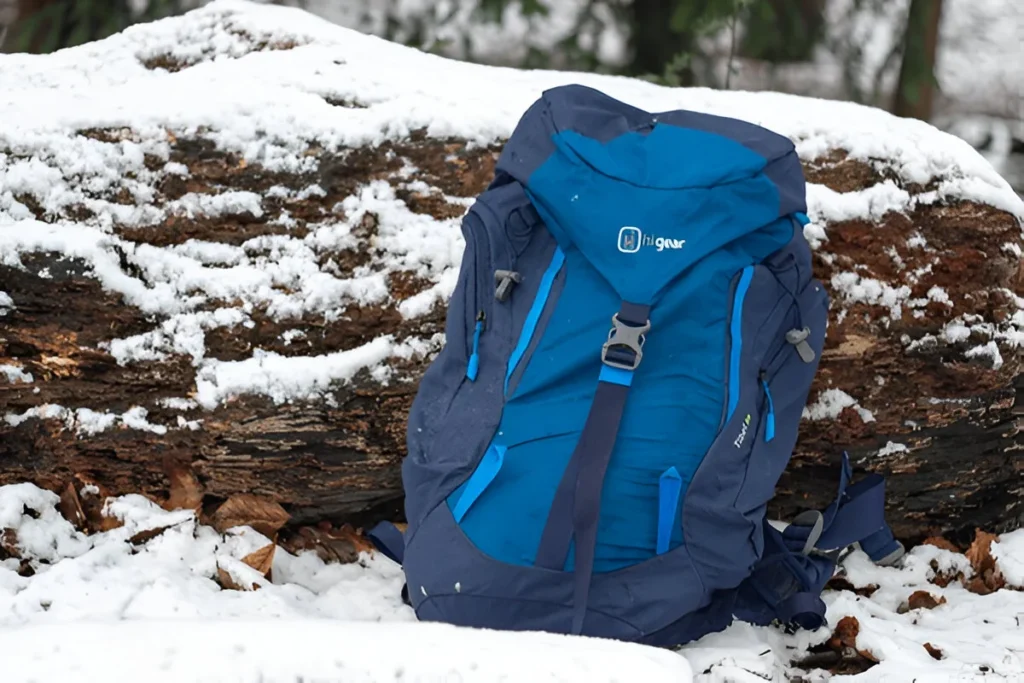 Hi Gear Tibet 35 Back Pack in the snow laid agaist a tree stump