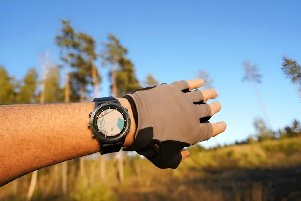 Smartwatch travel. Hiker checking map on sports watch. Expedition smartwatch. Watch for wild survival. Outdoor, hiking Watch on hand. GPS track in Smartwatch