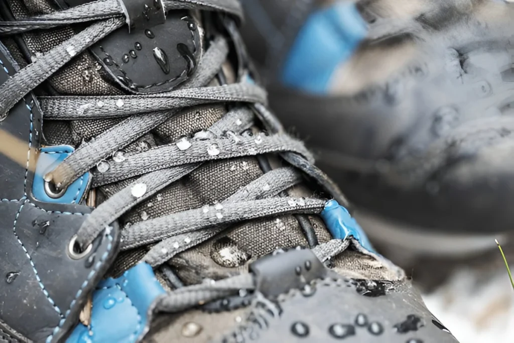 waterproof hiking boots. closeup of footwear with rain water drops