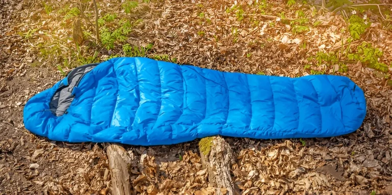 best sleeping bags lying on the grass. Warm sleeping sack on the ground. Outdoor camping equipment