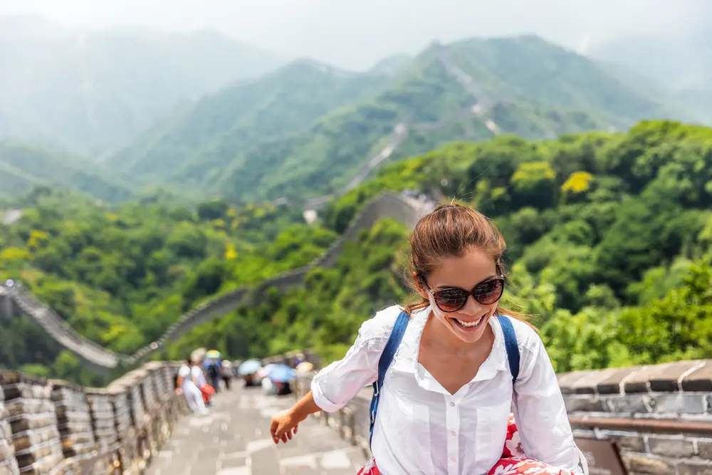 Tourist in Asia walking on famous Chinese tourist wearing sunglasses