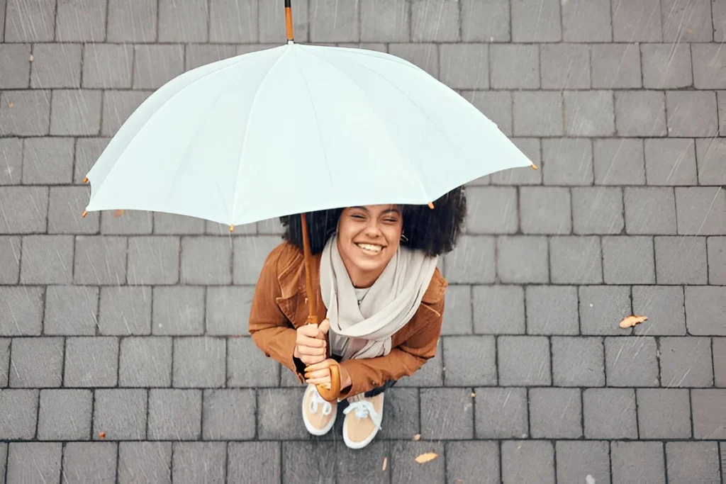 Happy, relax and girl with rain umbrella enjoying outdoor