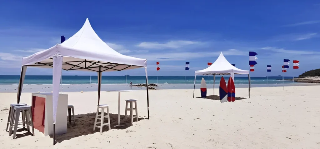 Sturdy white shelters on a sunny beach showcase the best canopy tents for shade, comfort, and coastal protection.