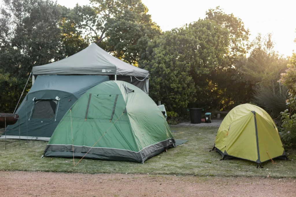 A campsite with multiple durable green tents set up on grass, ideal for showcasing the Best 4-Season Tents.